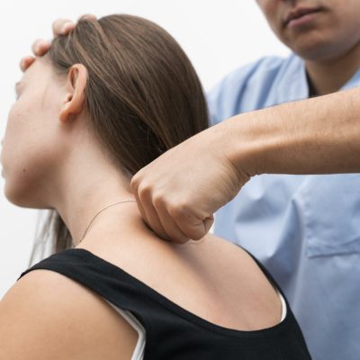 physiotherapist-massaging-woman-s-upper-back